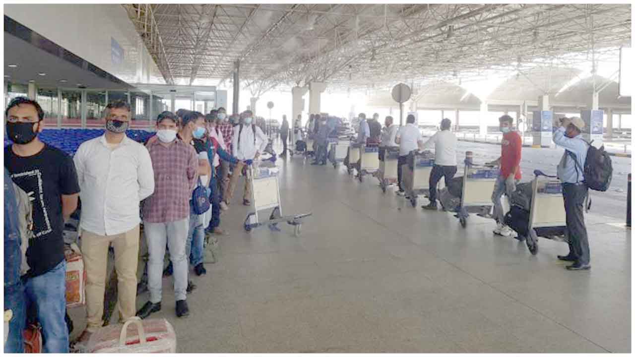 Check-in formalities being done for passengers travelling from Kuwait to Bhubaneswar via Delhi under VandeBharatMission
