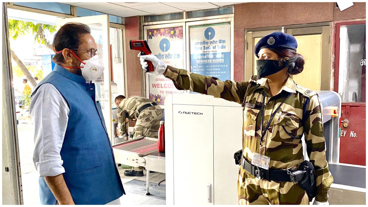 The Union Minister for Minority Affairs, Shri Mukhtar Abbas Naqvi during security person conducting Thermal Screening at entry gate of Minority Affairs Ministryâ€™s office in Antyodaya Bhawan, CGO Com